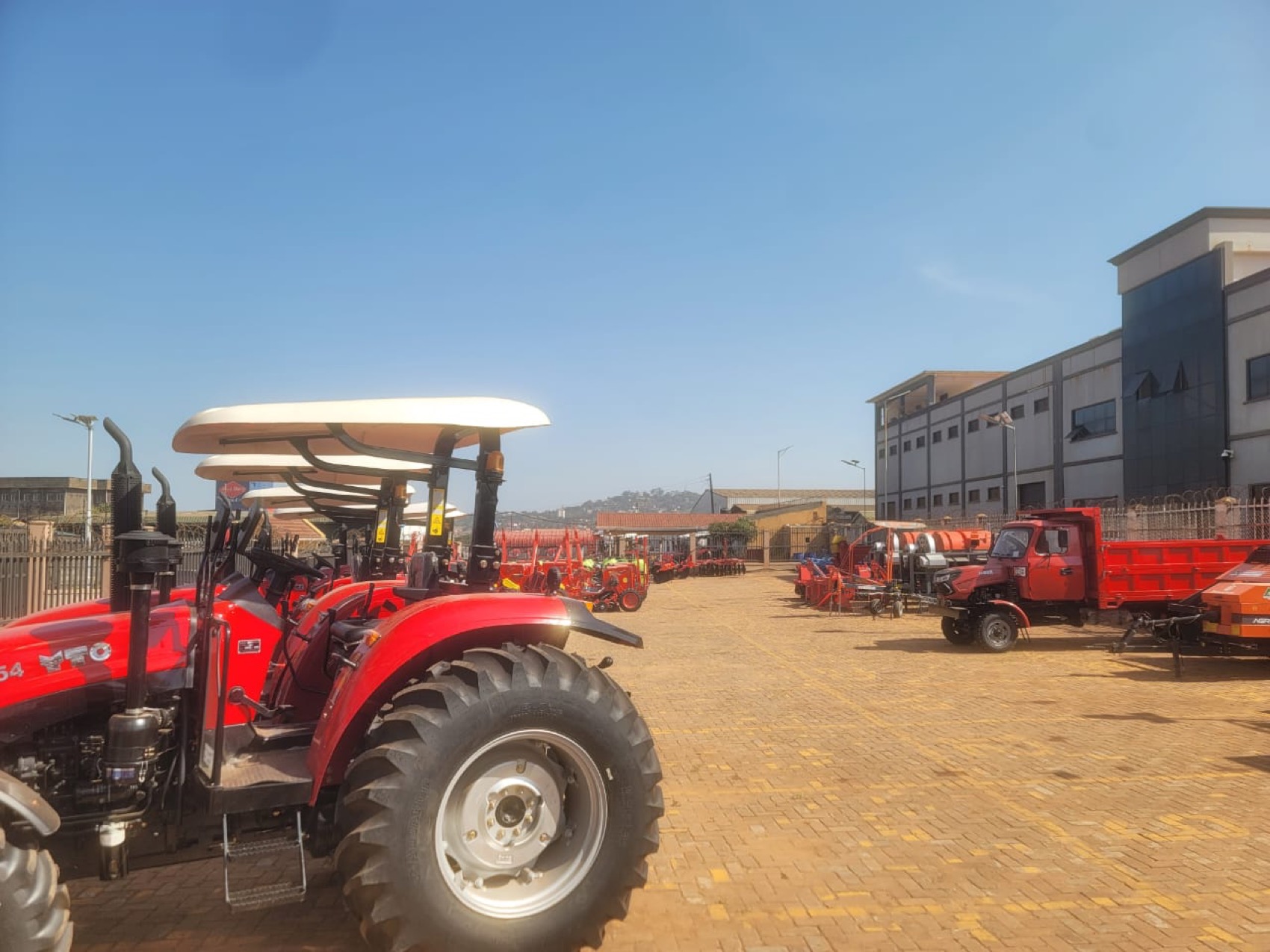 The Agro Corner yard in Kampala with tractors and implements lined up under an open sky